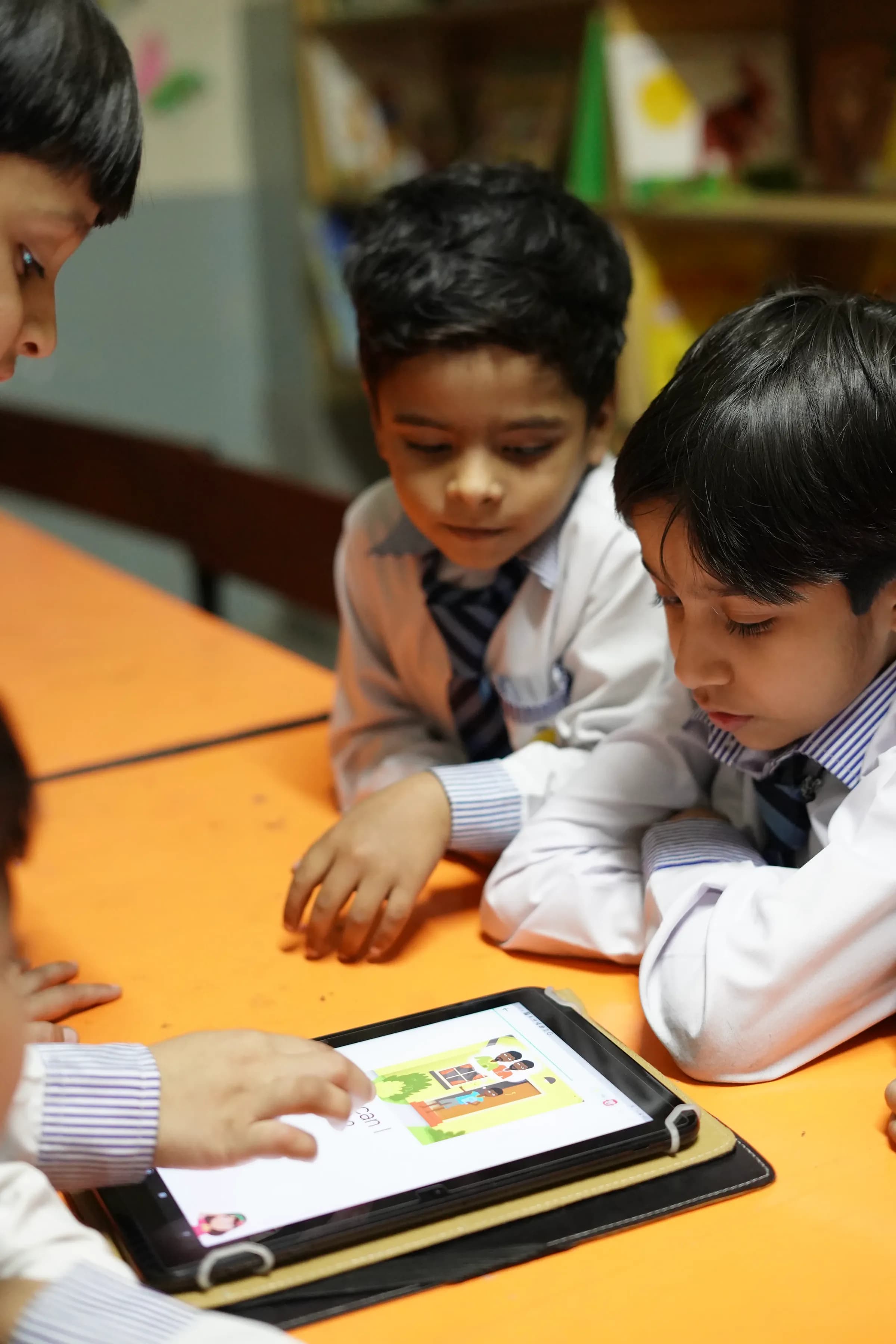 Farooqi Grammar School students using a tablet together